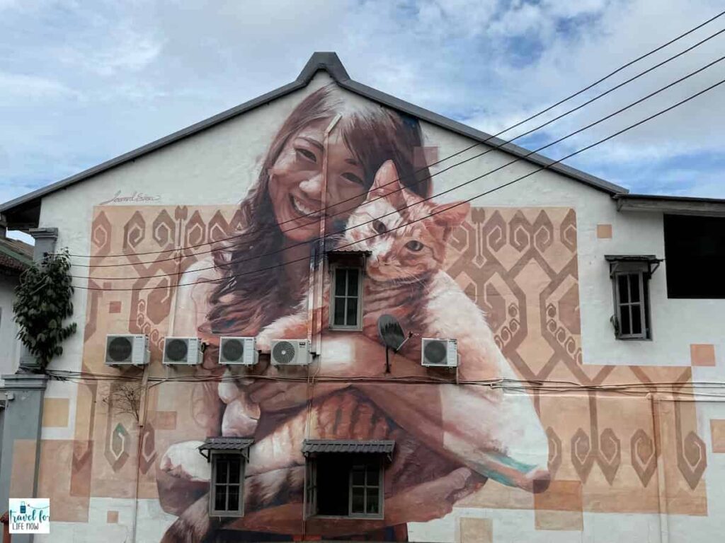 Mural of a woman holding a cat