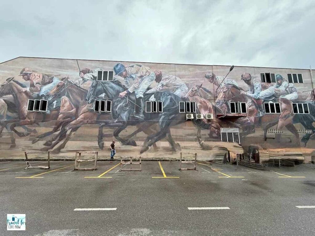 Mural of jockeys on racing horses