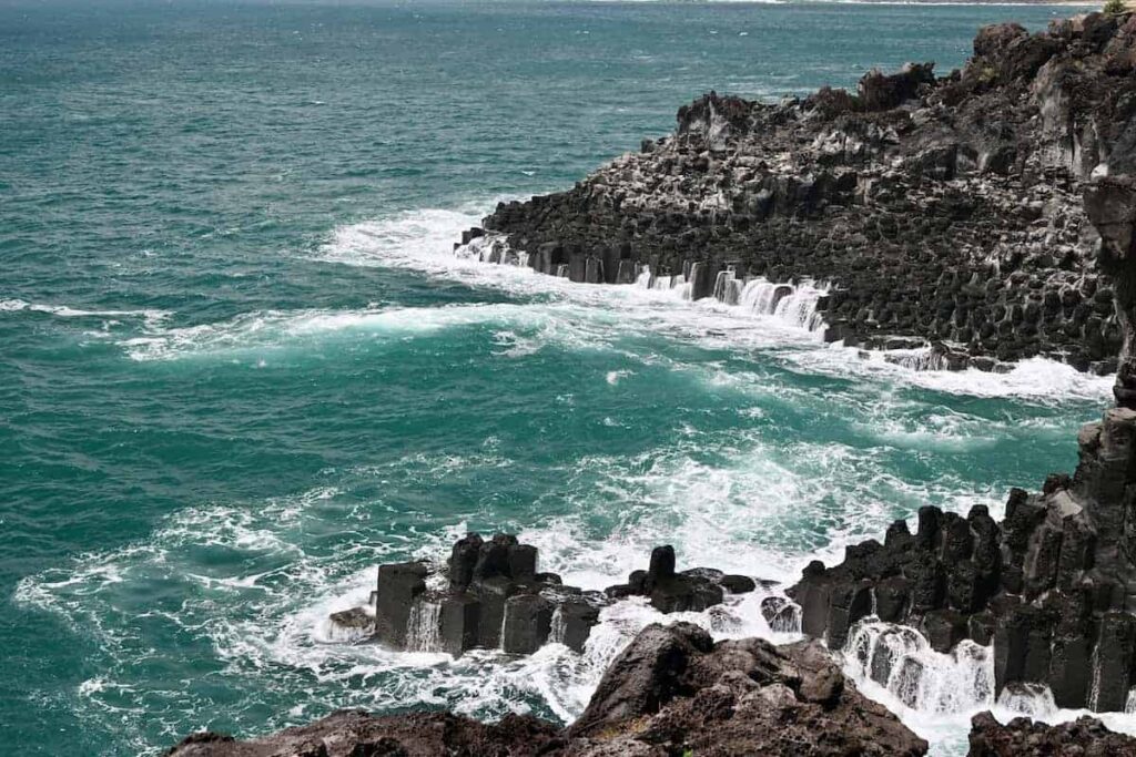 Black rock cliffs with ocean, Daepo Jusangjeolli Cliffs